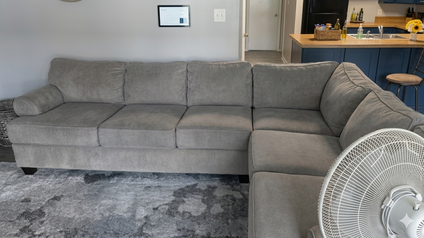 After — gray sectional sofa restored to uniform clean finish